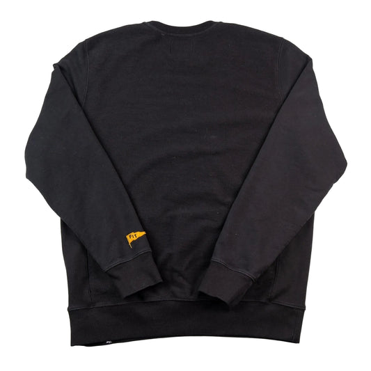 Black sweatshirt with a small yellow tag on a white background