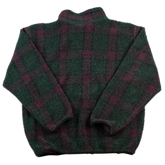 Folded green and purple plaid blanket on a white background