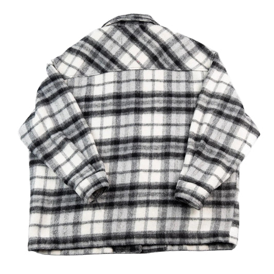 Folded black and white plaid shirt on a white background
