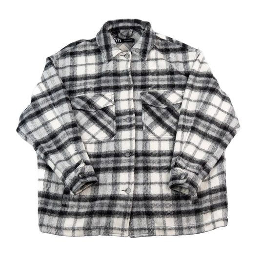 Plaid shirt with rolled-up sleeves on a white background