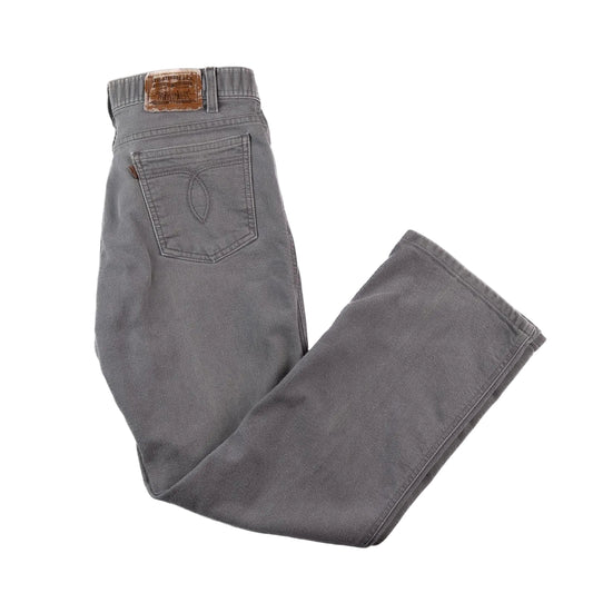 Gray jeans with a brown leather patch on a white background