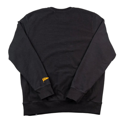 Black sweatshirt with a small yellow tag on a white background