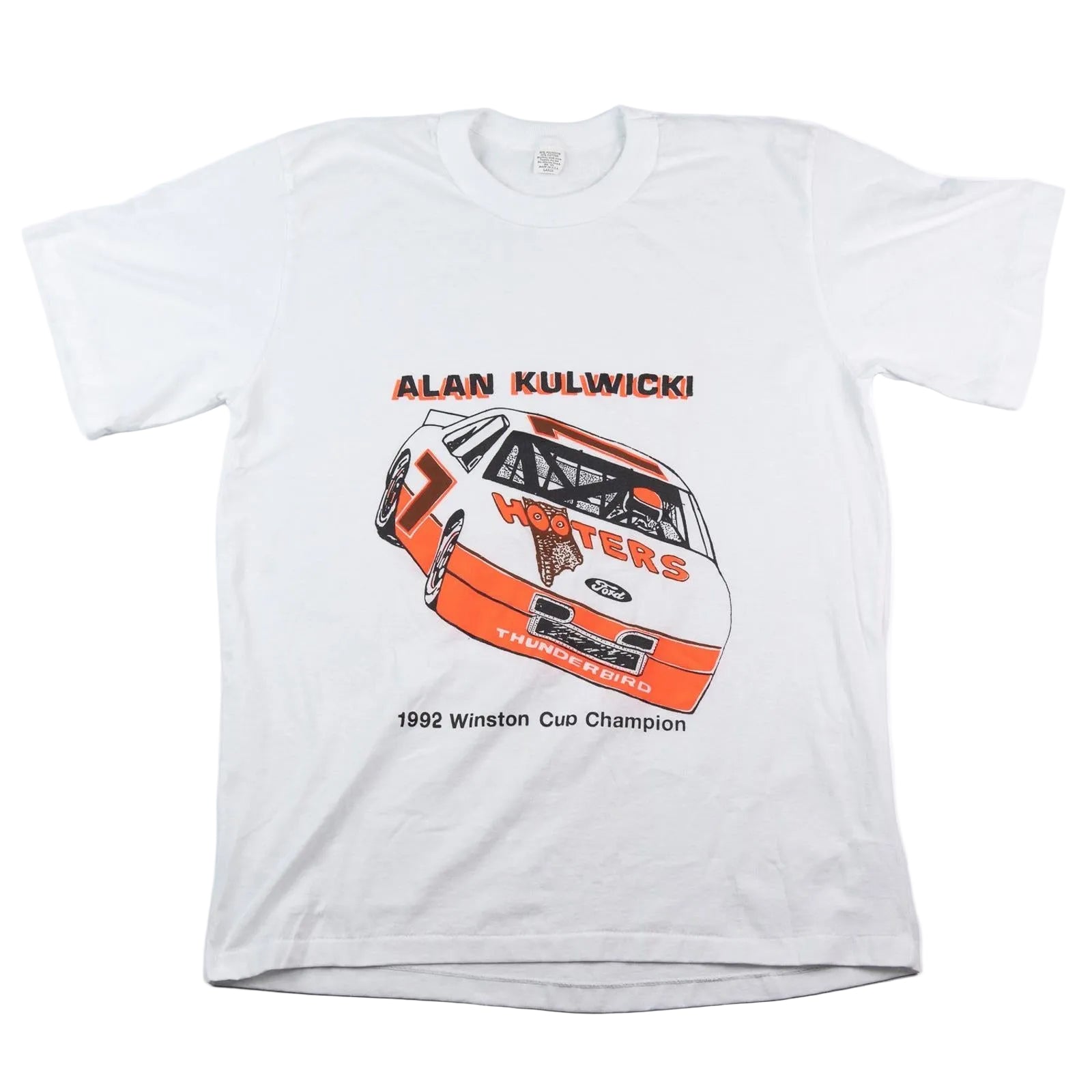White t-shirt with race car graphic and text on a white background