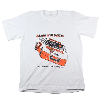 White t-shirt with race car graphic and text on a white background