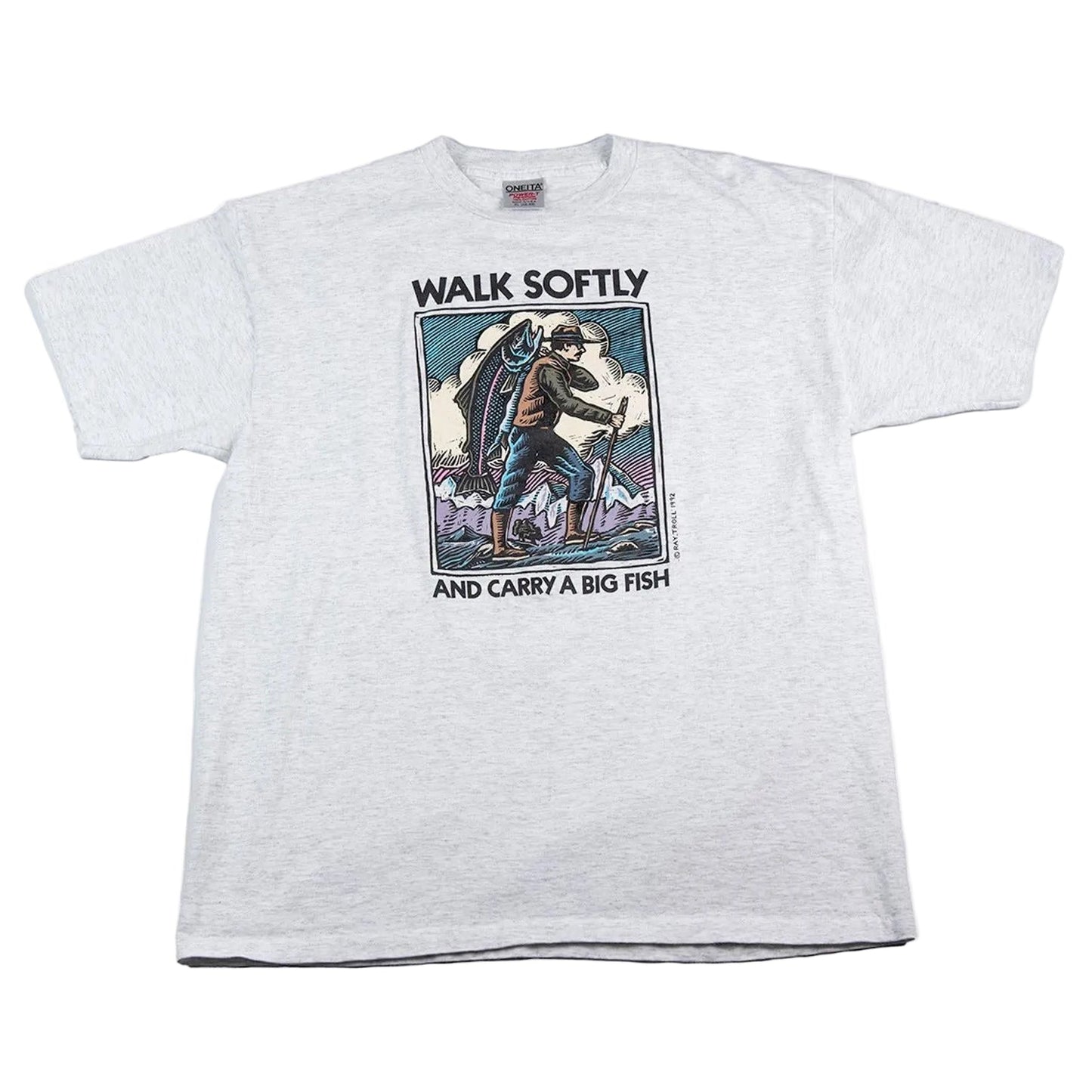 White t-shirt with graphic design and text 'Walk Softly and Carry a Big Fish' on a white background