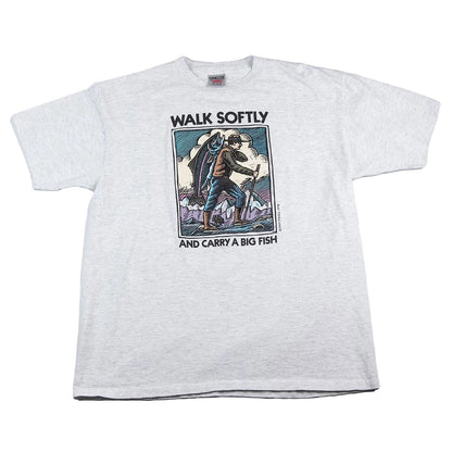 White t-shirt with graphic design and text 'Walk Softly and Carry a Big Fish' on a white background