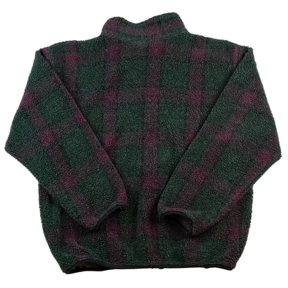 Folded green and purple plaid blanket on a white background