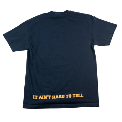 Black t-shirt with yellow text 'IT AIN'T HARD TO TELL' on a white background