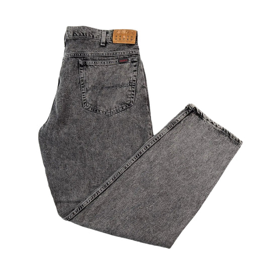Folded pair of gray jeans on a white background