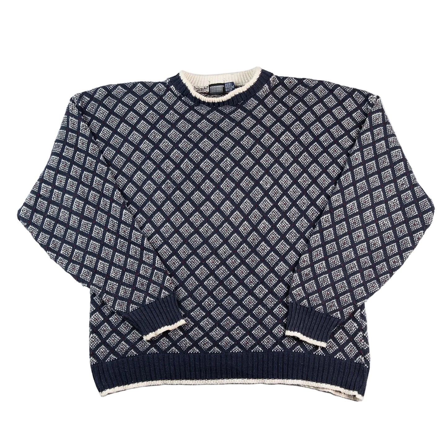 Navy blue and white patterned sweater on a white background