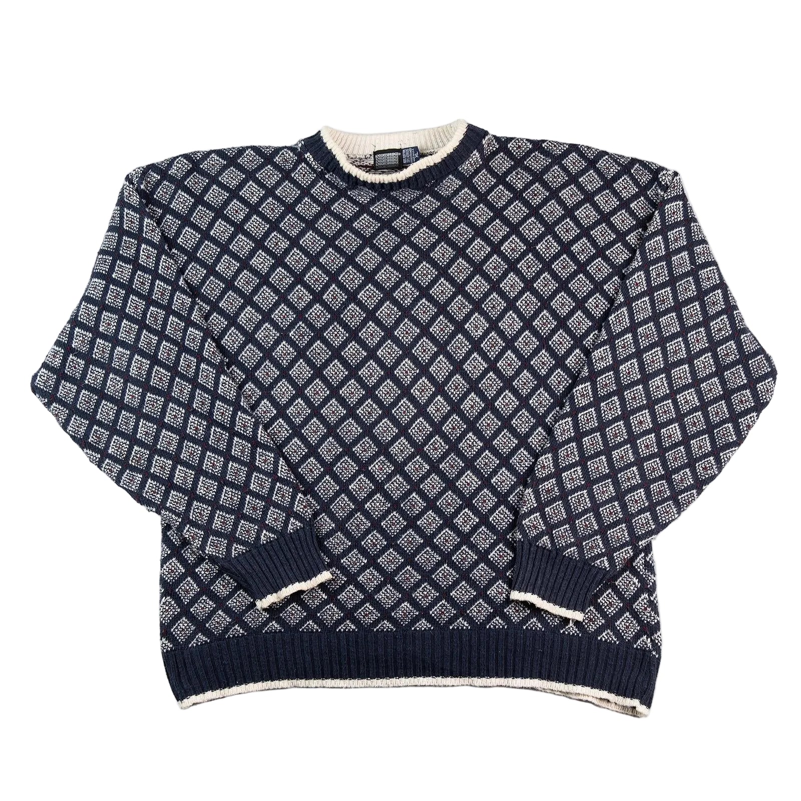 Navy blue and white patterned sweater on a white background