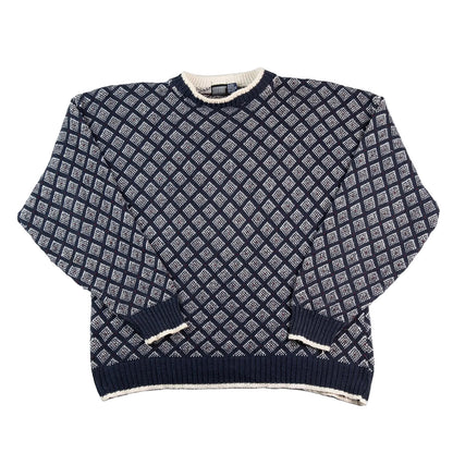 Navy blue and white patterned sweater on a white background