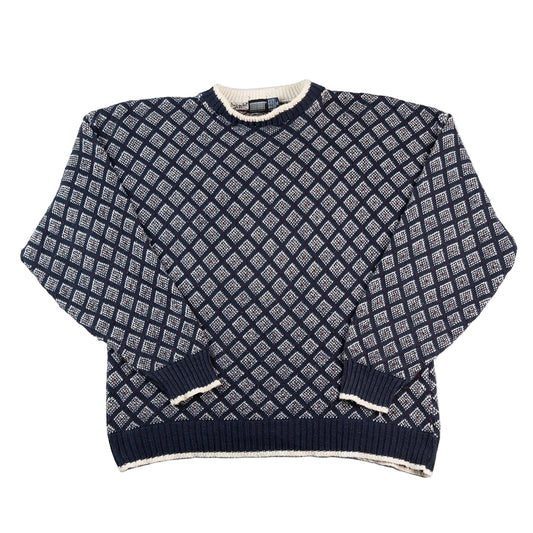 Navy blue and white patterned sweater on a white background