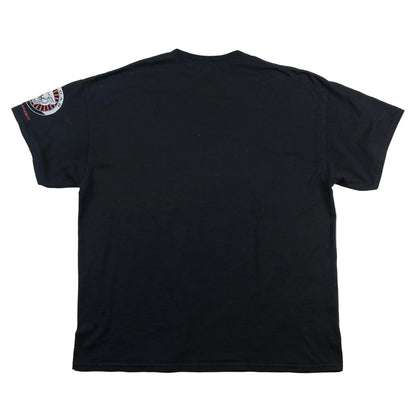 Black t-shirt with a patch on the sleeve against a white background
