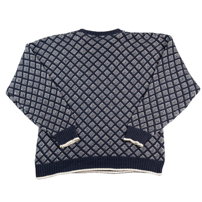 Navy blue and white patterned sweater on a white background