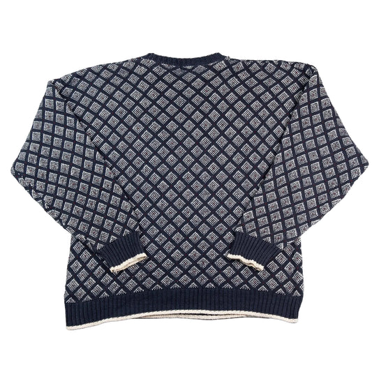 Navy blue and white patterned sweater on a white background